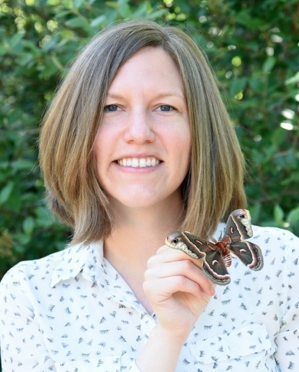 Headshot of Julie Peterson holding a moth.