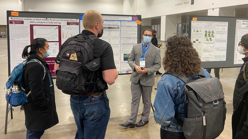 Entomology student presents research on poster.